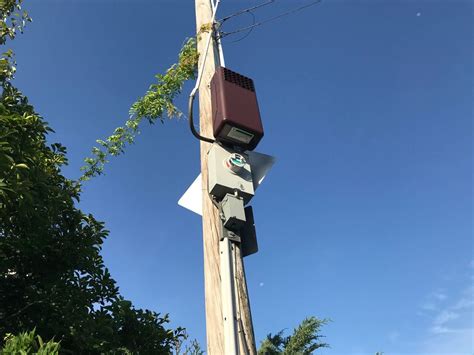 rectangular metal box on telephone pole|box on utility pole.